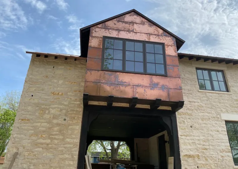 Copper metal panel facade on a stone building for Skylight Installation in Delanco